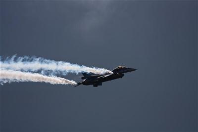 F16 and contrails in the clouds
